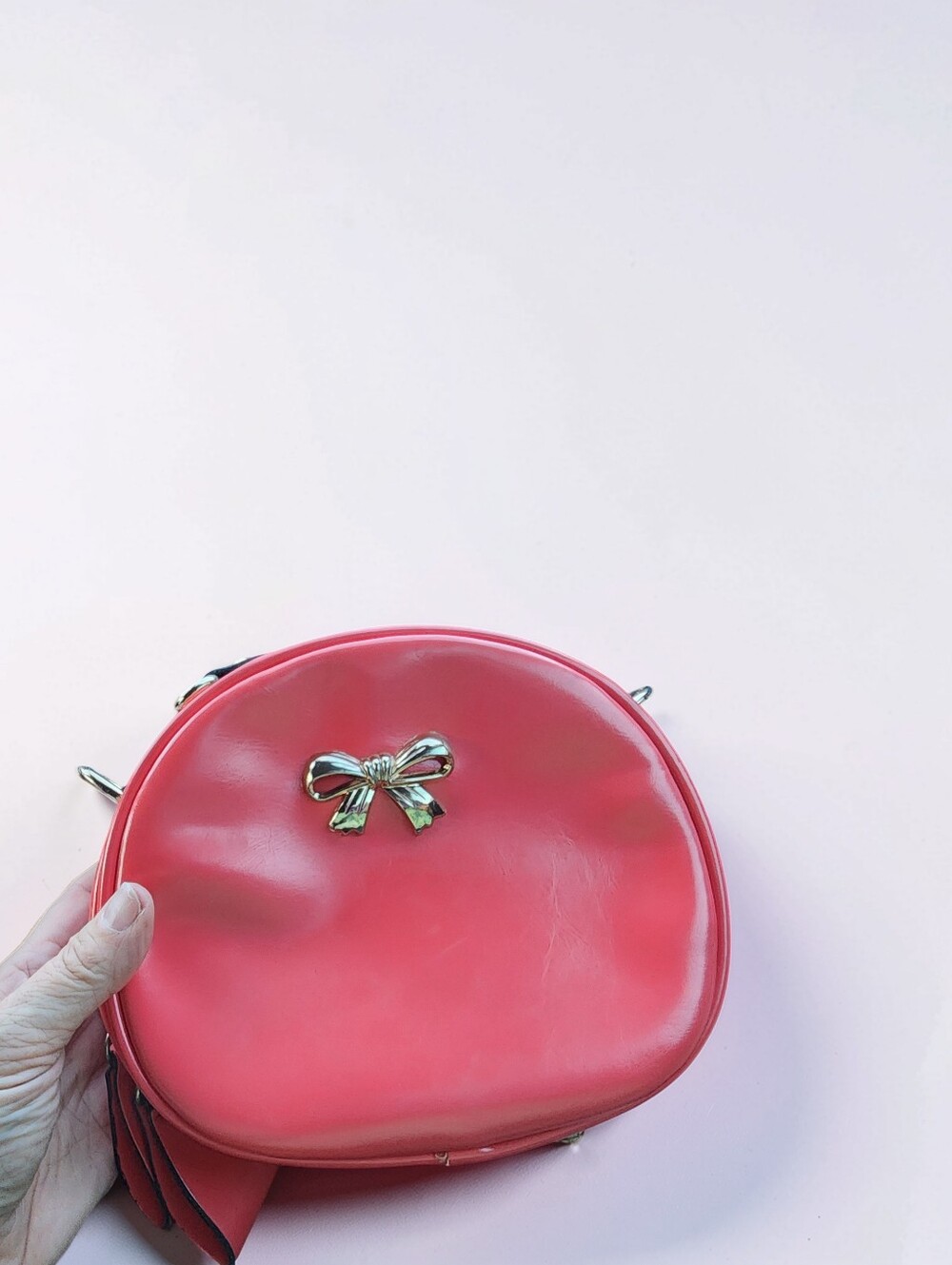 Bei Bao Bao Pink/Red Faux Leather Round Crossbody Bag with Gold Bow Accent